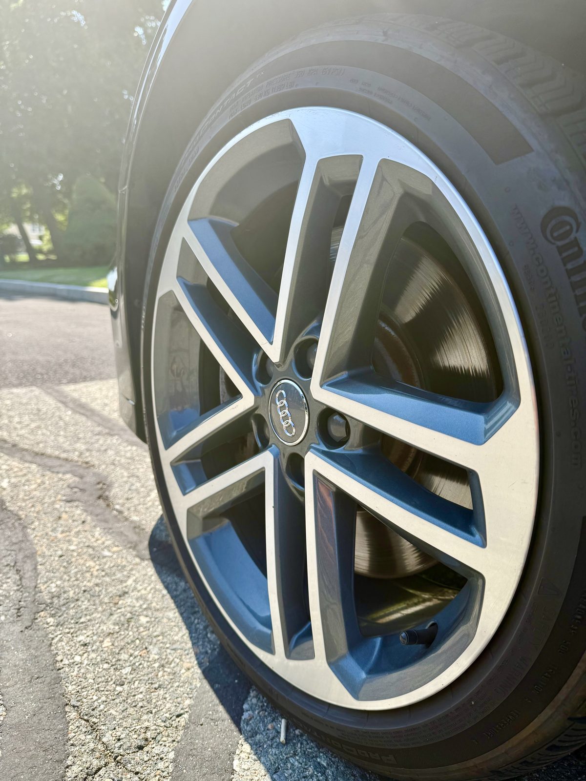 Close-up of a polished Audi five-double-spoke machined alloy wheel cleaned free of brake dust