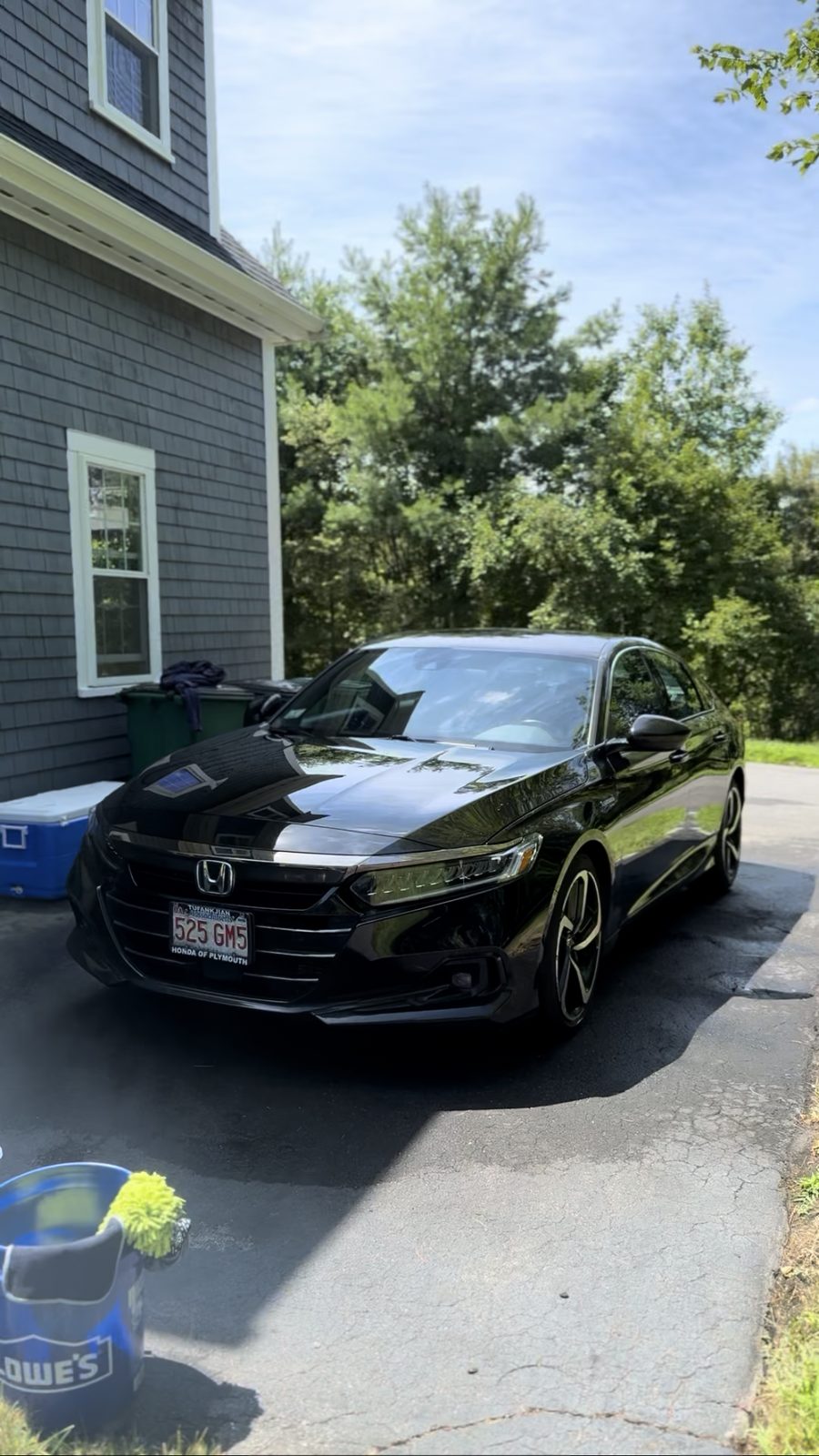 Black Honda Accord after a full detail, paint reflecting the sky and trees
